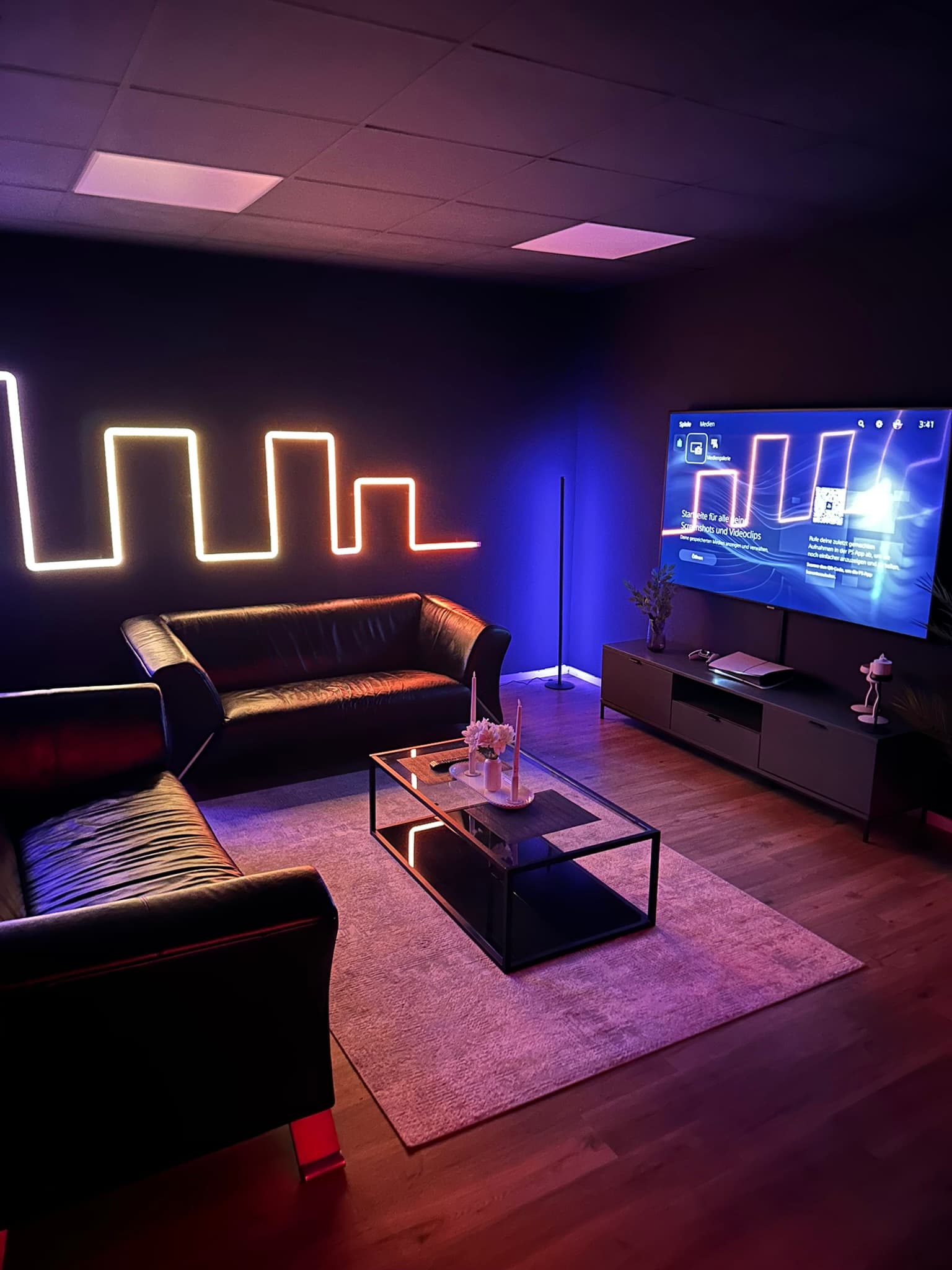 PS5 Lounge Area mit Ambient Neon Beleuchtung und Ledercouch